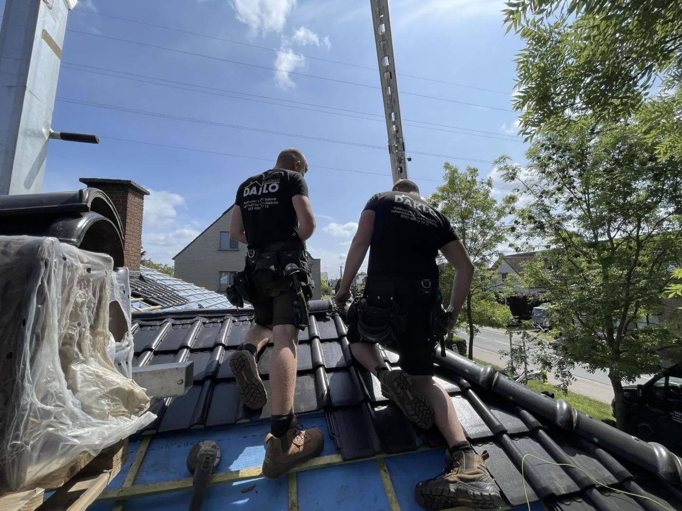 Dakwerkers van Daklo aan het werk op een dak in renovatie